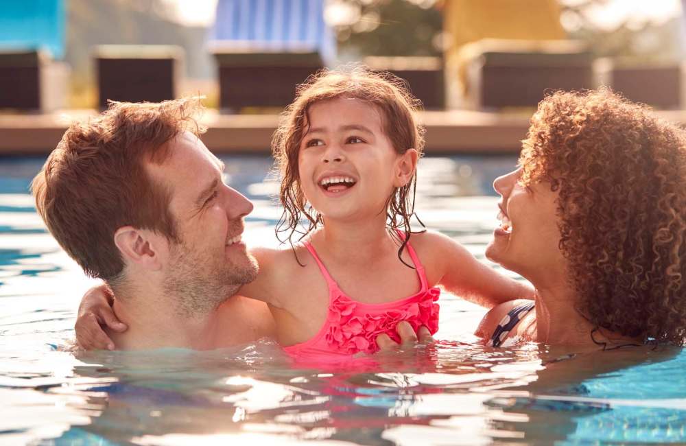 Resident family enjoying in pool at The Morgan in Bedford, Texas