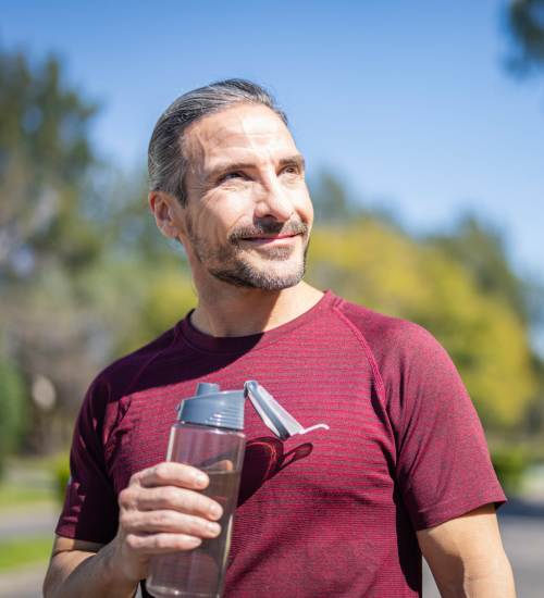 Resident sipping water while jogging at Unionville Station Townhomes in Hilton, New York