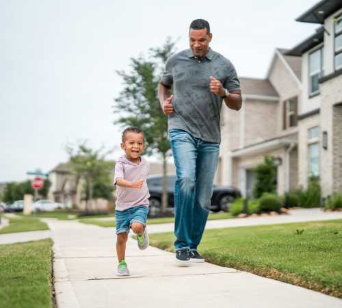 Father and child playing at Parkwood Oaks in Bedford, Texas