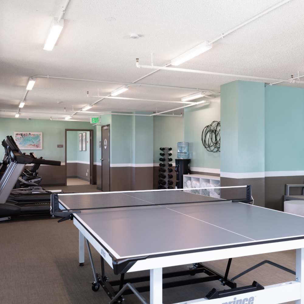 Fitness equipment and ping pong table at Golden West Tower Apartments in Torrance, California
