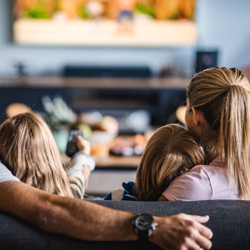 Family watching TV at Adobe Flats III in Twentynine Palms, California