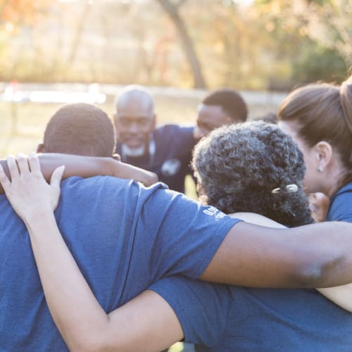 A group of employees conversing at Liberty Military Housing in Newport Beach, California