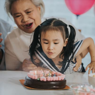 Resident celebrating a birthday with her grandchild at Peoples Senior Living in Tacoma, Washington