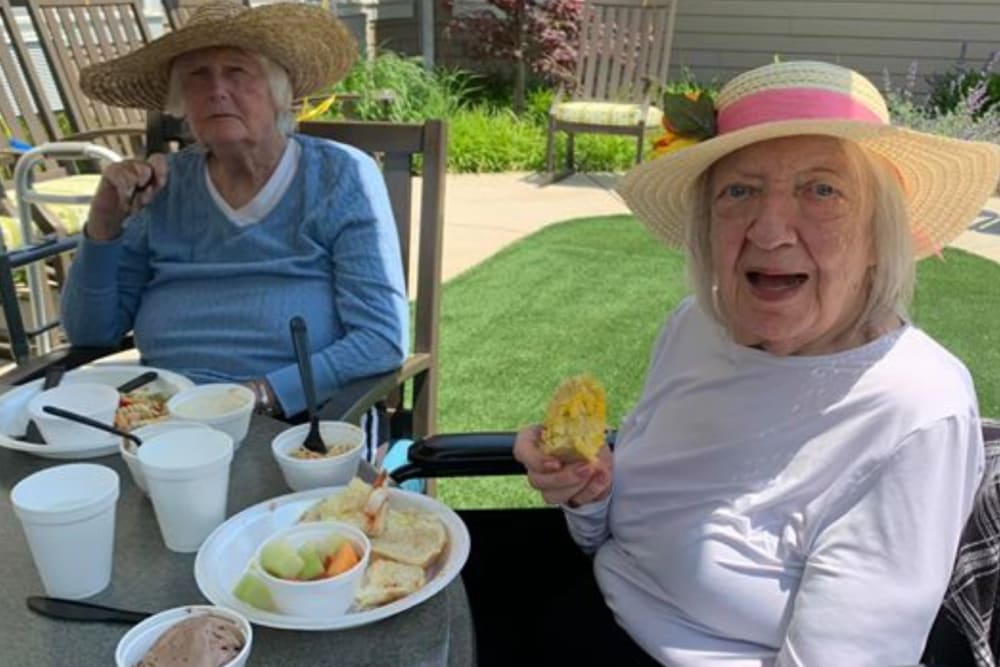 Senior residents enjoying a meal outside