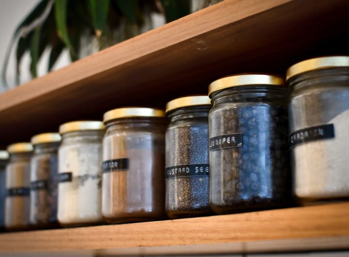 Clear jars labeled with various spices