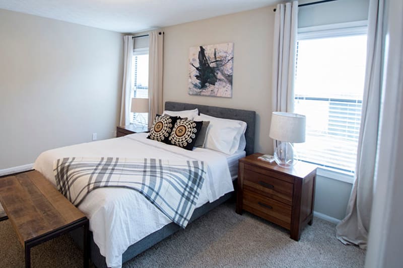 Spacious model home's primary bedroom with plush carpeting at The Everette at East Cobb in Marietta, Georgia