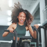 A woman stretching in the fitness center at Astoria in Mobile, Alabama