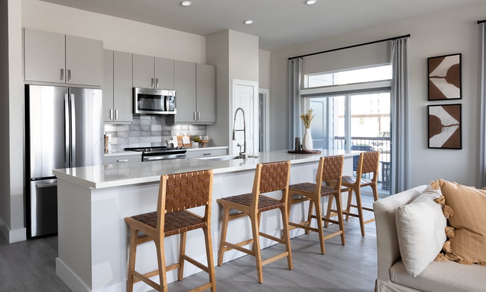 Resident apartment kitchen with counter seating at Bellrock La Frontera in Austin, Texas