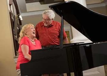 Residents playing piano at Discovery Village At Alliance Town Center in Fort Worth, Texas