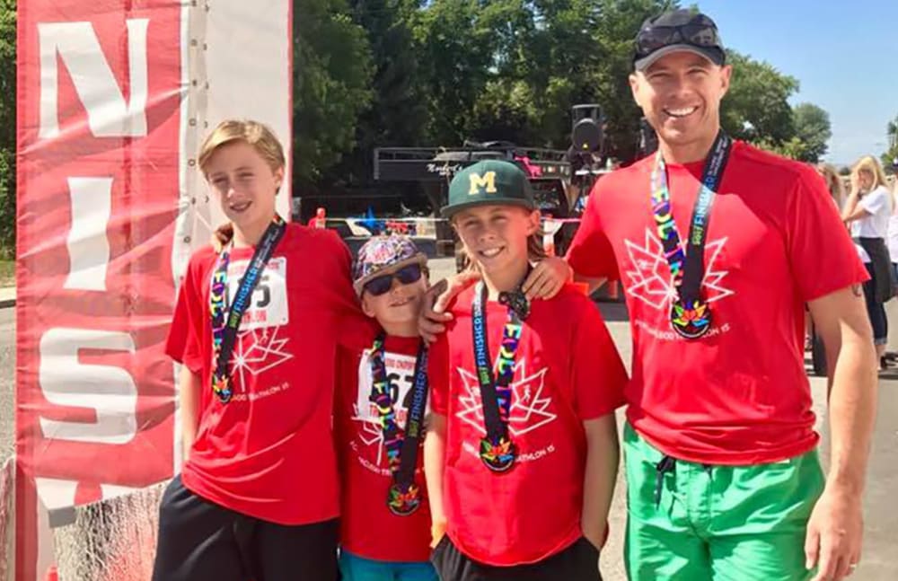 Thomas from Touchmark at Wedgewood in Edmonton, Alberta competing in a triathlon with his sons.