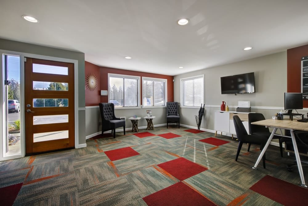 Multiple tables with chairs in community clubhouse at Terra Apartment Homes in Federal Way, Washington