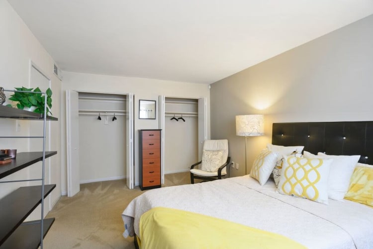 Well-decorated bedroom with plush carpeting in a model home at Capital Crossing in Suitland, Maryland
