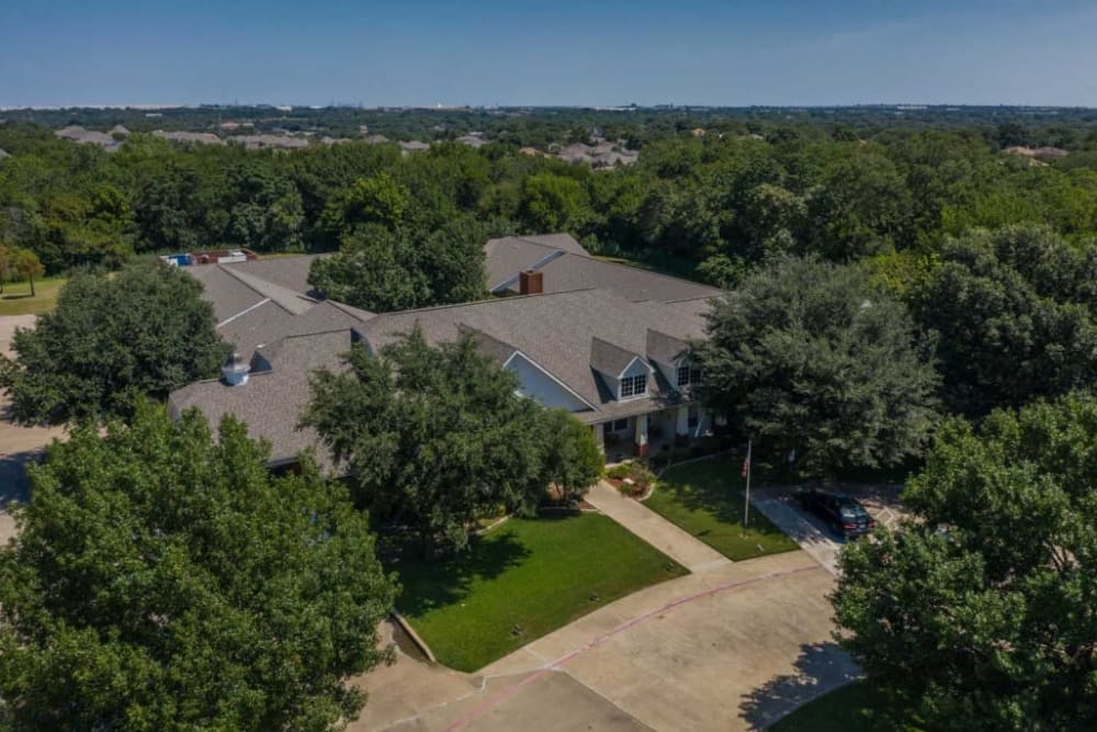 Aerial view of property with trees at Deer Creek Senior Living in Desoto, Texas