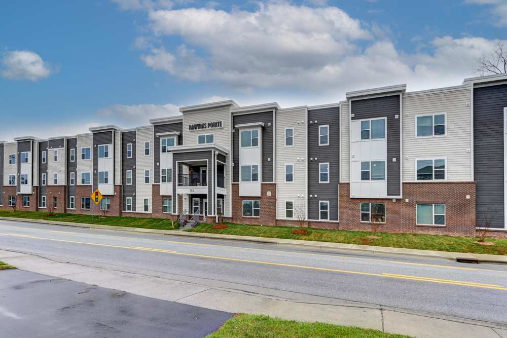 Modern apartment community with landscaped grounds and welcoming entrance at Hawkins Pointe in Hendersonville, North Carolina