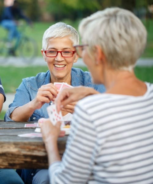 Residents playing cards on the patio at Vancouver Pointe in Vancouver, WA.
