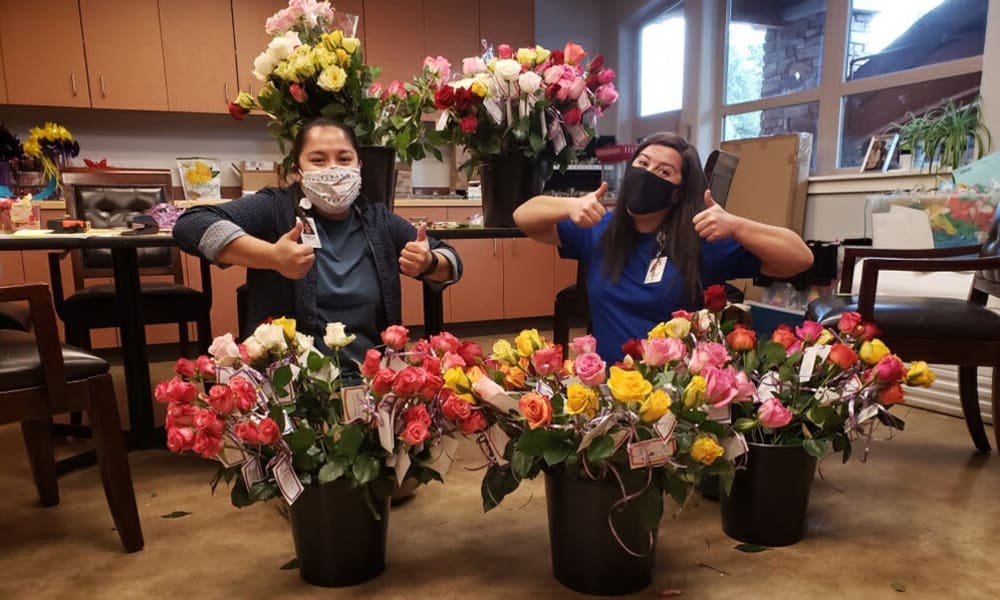 Team members at Touchmark Central Office in Beaverton, Oregon prepare flowers for residents