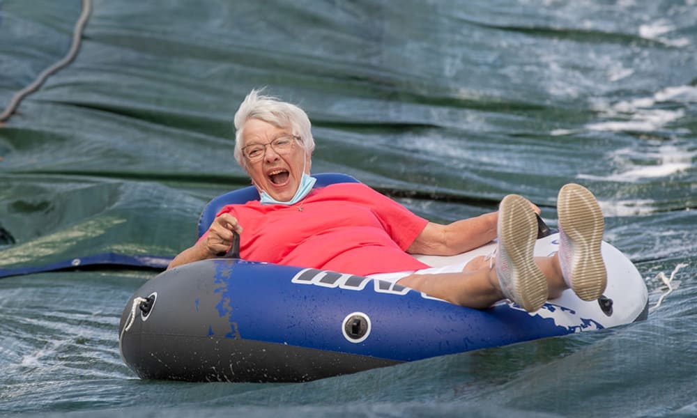 Residents enjoying outdoor slip and slide.