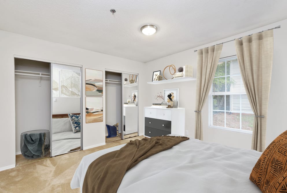 Bedroom with plush carpet at Austell Village Apartment Homes in Austell, Georgia