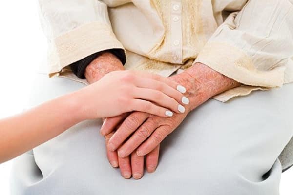 Lady holding hands with a resident at The Retreat at Carolina Bay in Hartsville, South Carolina