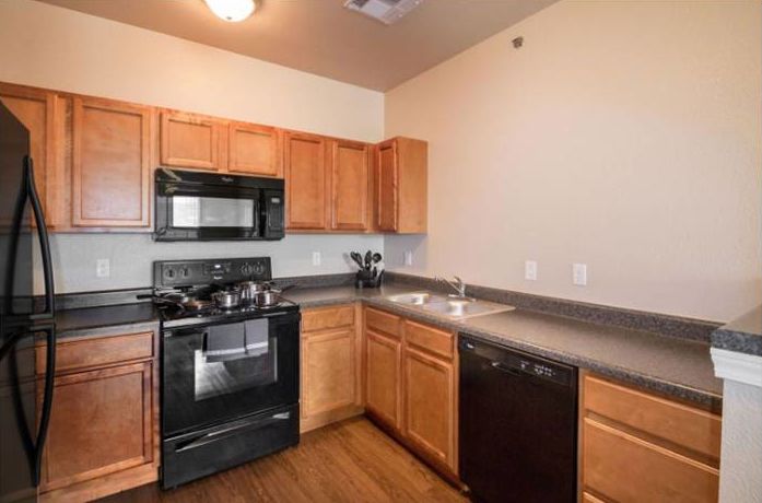Spacious kitchen with Wood-Style Flooring at The Reserves at Brookside in Borger, Texas