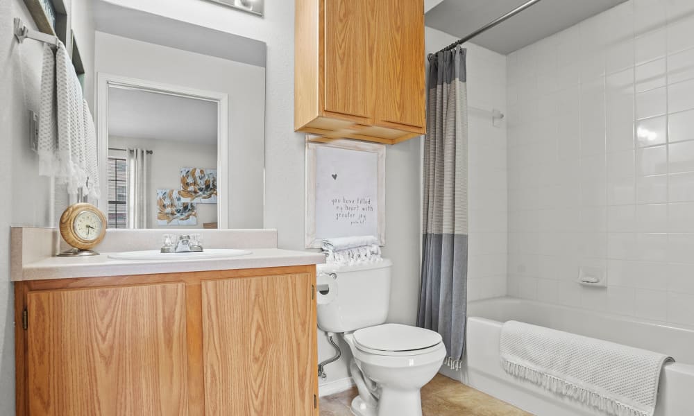 Bathroom with lots of lights  at The Remington Apartments in Wichita, Kansas