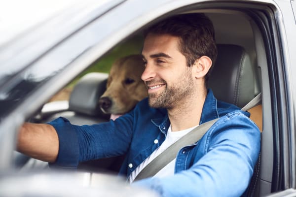 Resident smiling while driving his car to work near Antigua at Lakewood Ranch in Lakewood Ranch, Florida