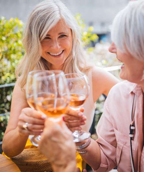 Residents enjoying a glass of wine at Athens Vista Senior Apartments in Los Angeles, California