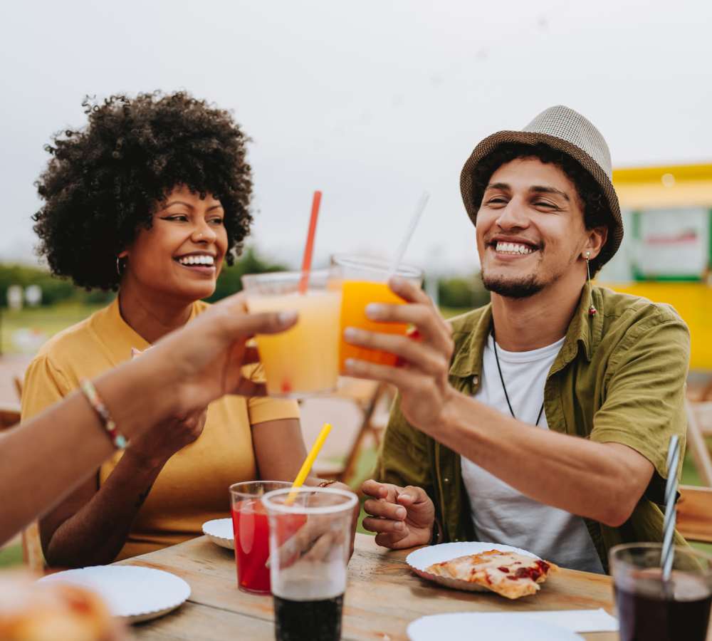 Smiling woman with curly hair holding a drink at Avia Lofts at Maple Road in Amherst, New York 