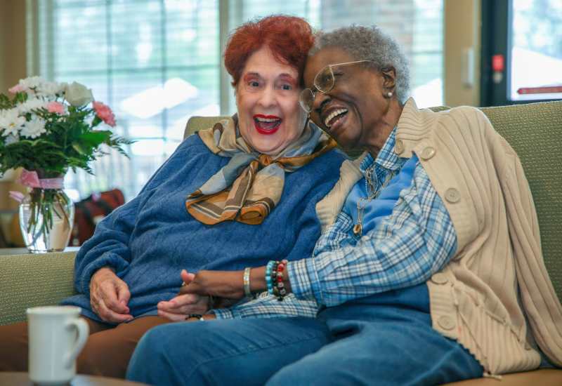 Resident friends embracing at Truewood by Merrill, Glen Riddle in Glen Riddle, Pennsylvania