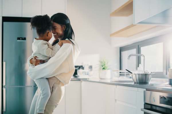 Woman hugging her child in a spacious kitchen with stainless steel eqipment at  Prosper 83 in Sparks, Nevada