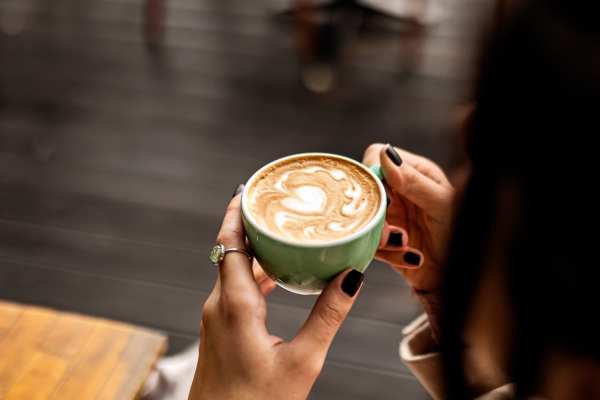 Woman with a cup of coffee at The Canopy Apartment Villas in Orlando, Florida