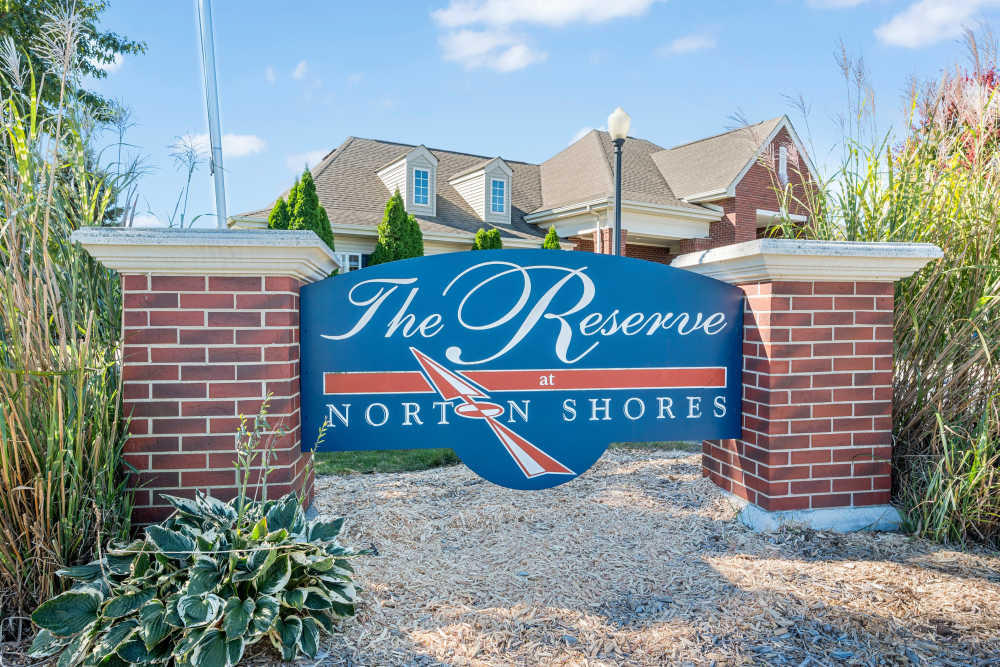 Large property name board at the front of the property at The Reserve at Norton Shores in Norton Shores, Michigan
