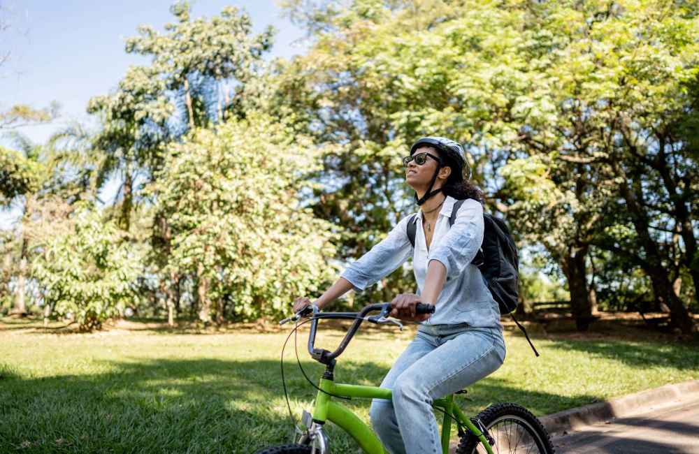 A resident woman cycling at a park near Mansions at Riverside in Tulsa, Oklahoma