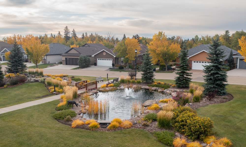 Photo of pond and independent living houses at Touchmark at Wedgewood in Edmonton, Alberta answering the telephone