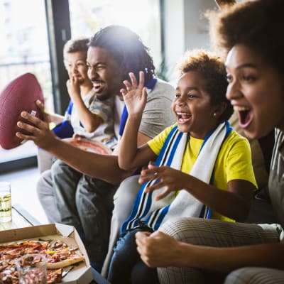 A family watching a football game together at Claremont Towers in Hillsborough, New Jersey