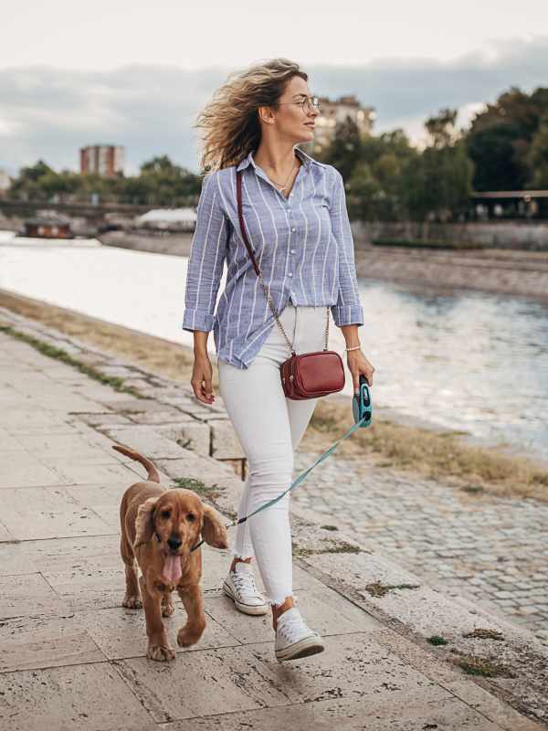 Resident on an evening walk with her dog near Visions at Willow Pond in West Palm Beach, Florida