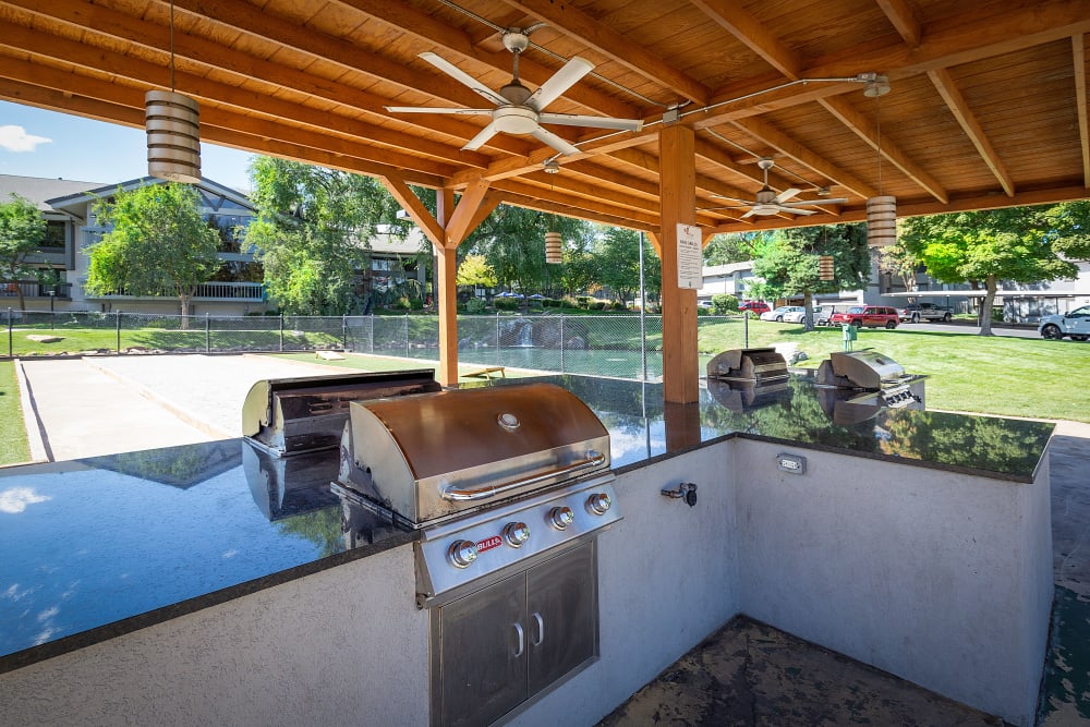 Outdoor grilling area at Springs of Country Woods Apartments in Midvale, Utah