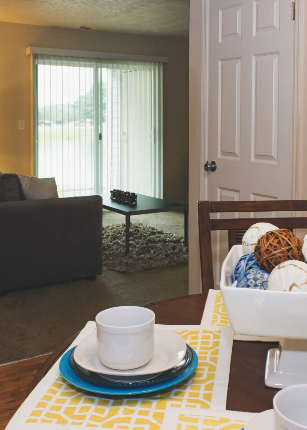 Model dining table into living room at Castleton Manor Apartments in Indianapolis, Indiana