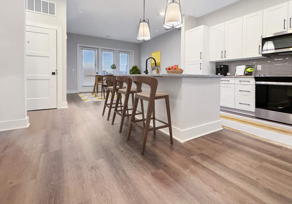A stylish modern kitchen equipped with stainless steel appliances at EVOQ East Cobb in Marietta, Georgia