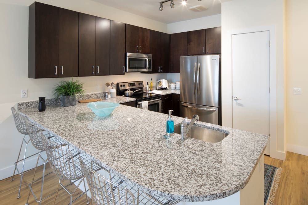 Kitchen with breakfast bar seating at The Residences at Annapolis Junction in Annapolis Junction, Maryland