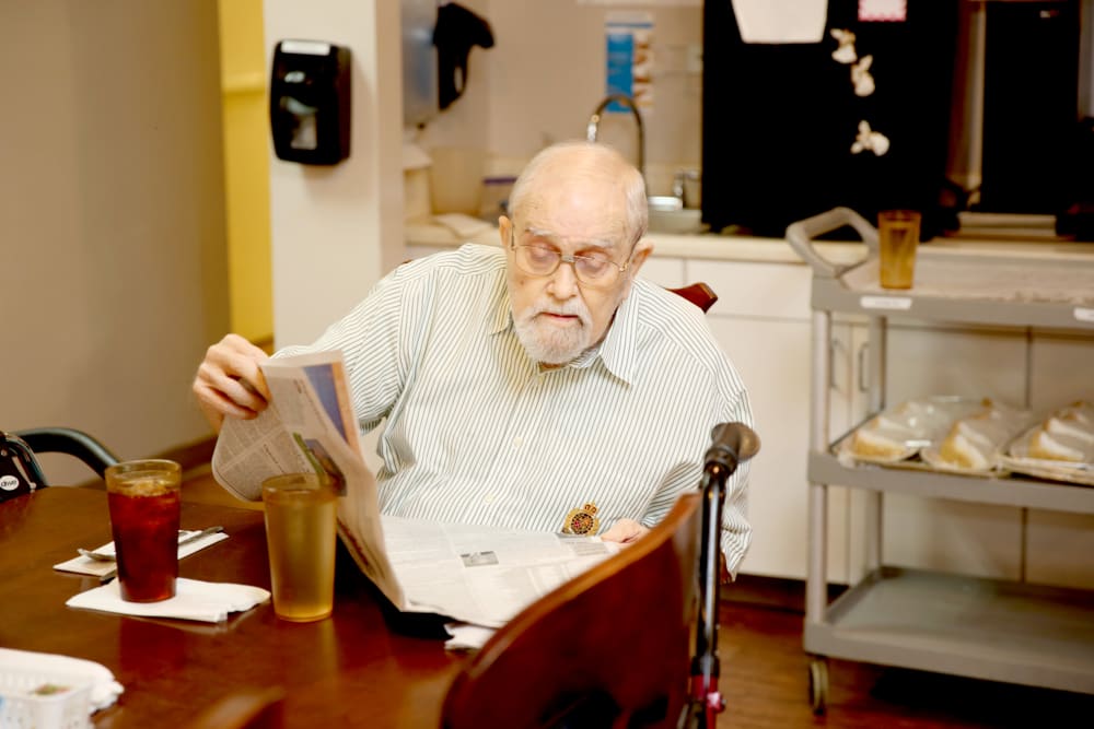 A resident reading the newspaper at Providence Assisted Living. 