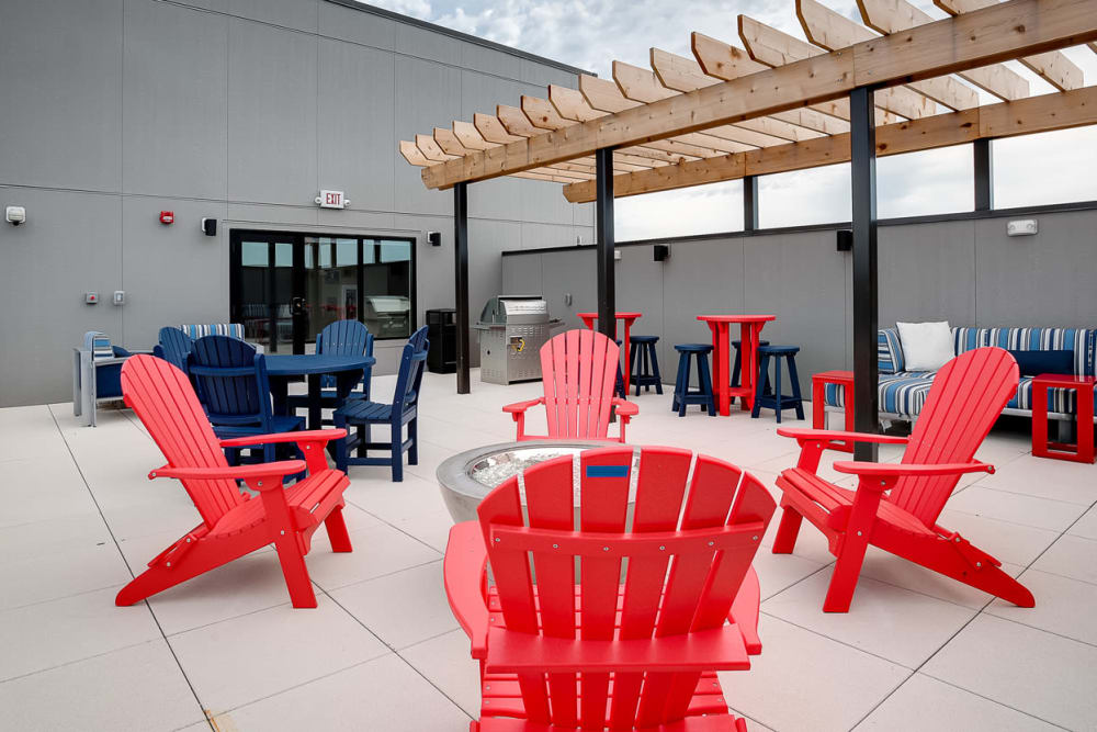 Resident sundeck with comfortable seating and a grilling station at Lake Jonathan Flats in Chaska, Minnesota