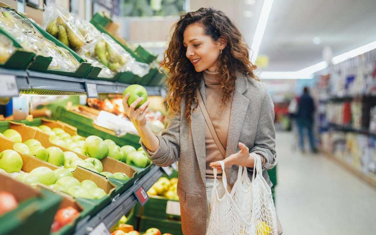 Resident woman buying groceries at a supermarket near Lake Forest in Daphne, Alabama