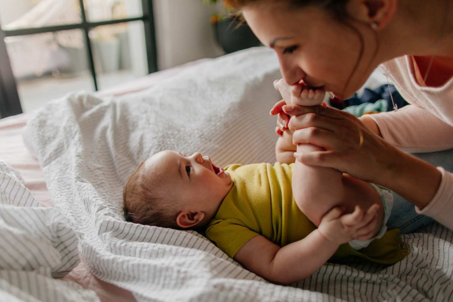 Mother playing with her child in the bedroom at Park Terrace Heights II in Columbia City, Indiana