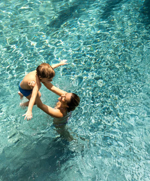 Resident in swimming pool holding her kid at Lakewood Apartments at Lake Merced in San Francisco, California at Lakewood Apartments at Lake Merced in San Francisco, California