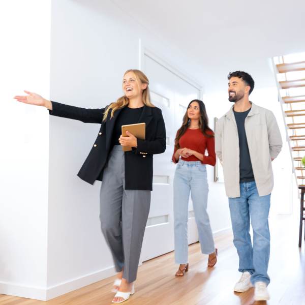 A woman showing a couple an apartment managed by Peters Residential in Culver City, California