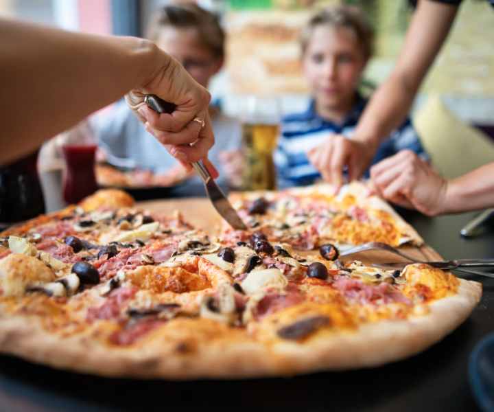 Resident having pizza near Meridian Oaks in Tallahassee, Florida
