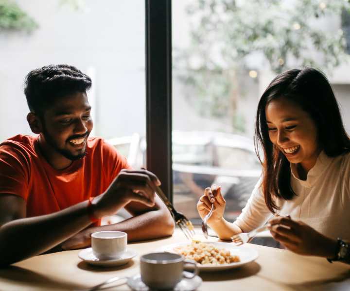 Resident couple enjoying their food at a restaurant near Amelia Apartments in Fayetteville, North Carolina