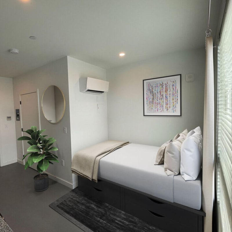 Bedroom with queen-size bed, air conditioner and window at Martin Flats in Nashville, Tennessee