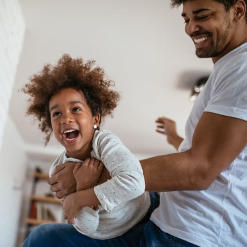 A father playing with his daughter at On Base Housing in Yuma, Arizona